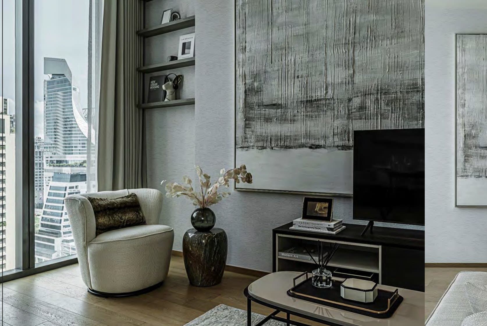 Corner vignette with cream bouclé swivel chair, marble vase of dried stems, floating shelves and a textured monochrome artwork above the media unit