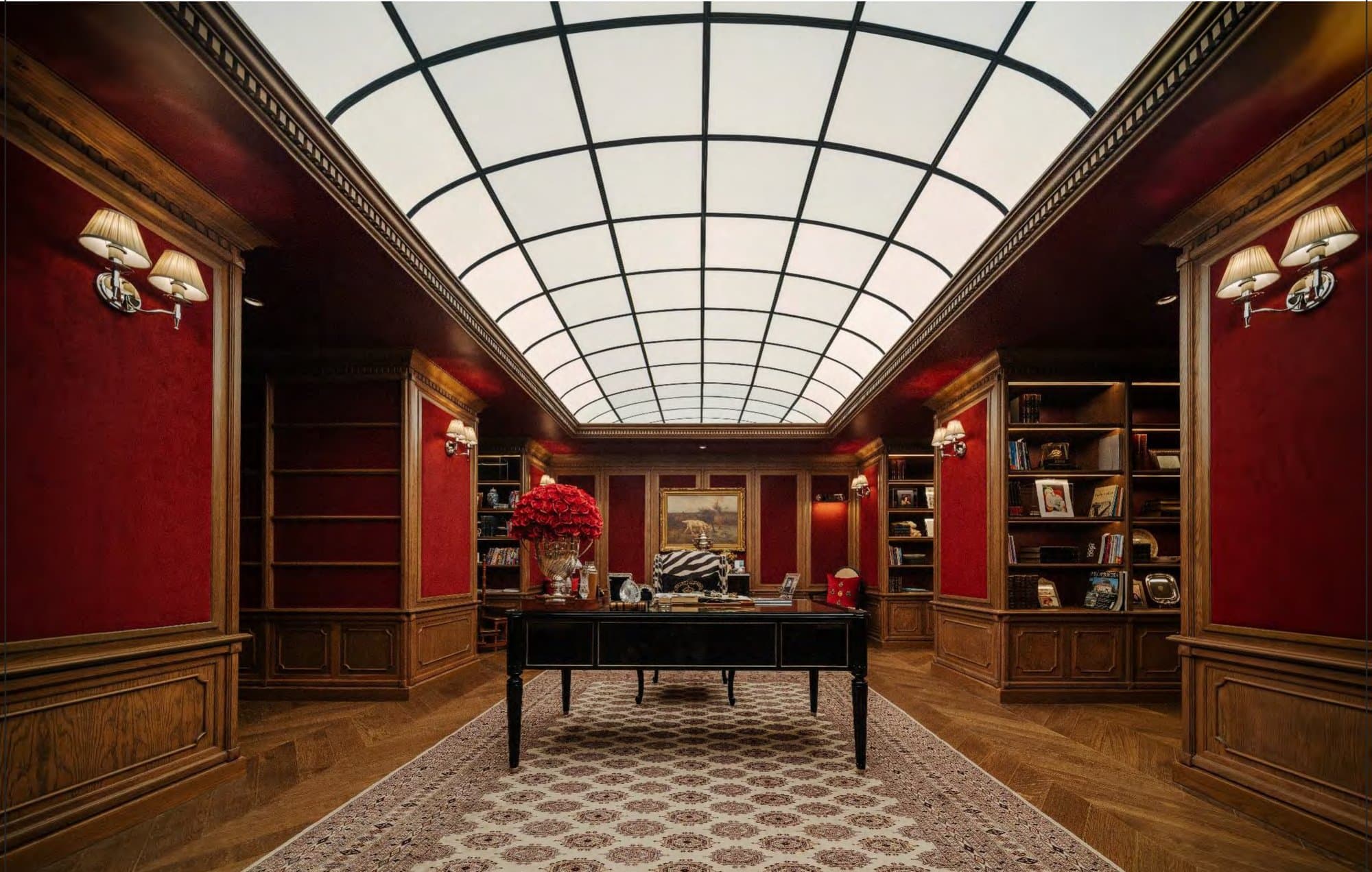 Oxblood-red study beneath a barrelled glass skylight, walnut bookcases, a black writing desk and a patterned rug between sconce-lit walls.