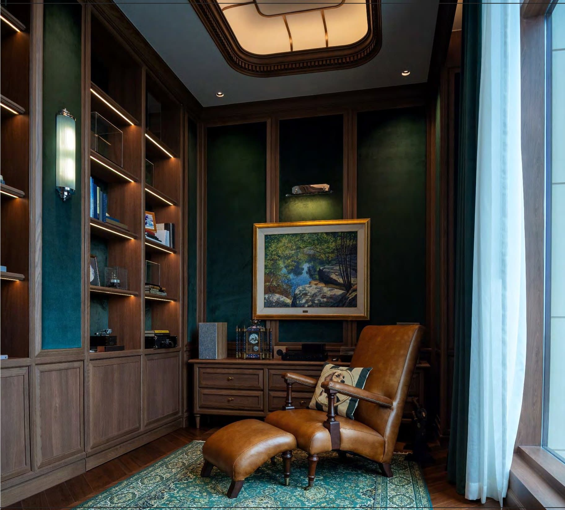 Green-panelled reading nook with backlit walnut shelving, a tan leather recliner and ottoman, and a framed landscape above a low cabinet.