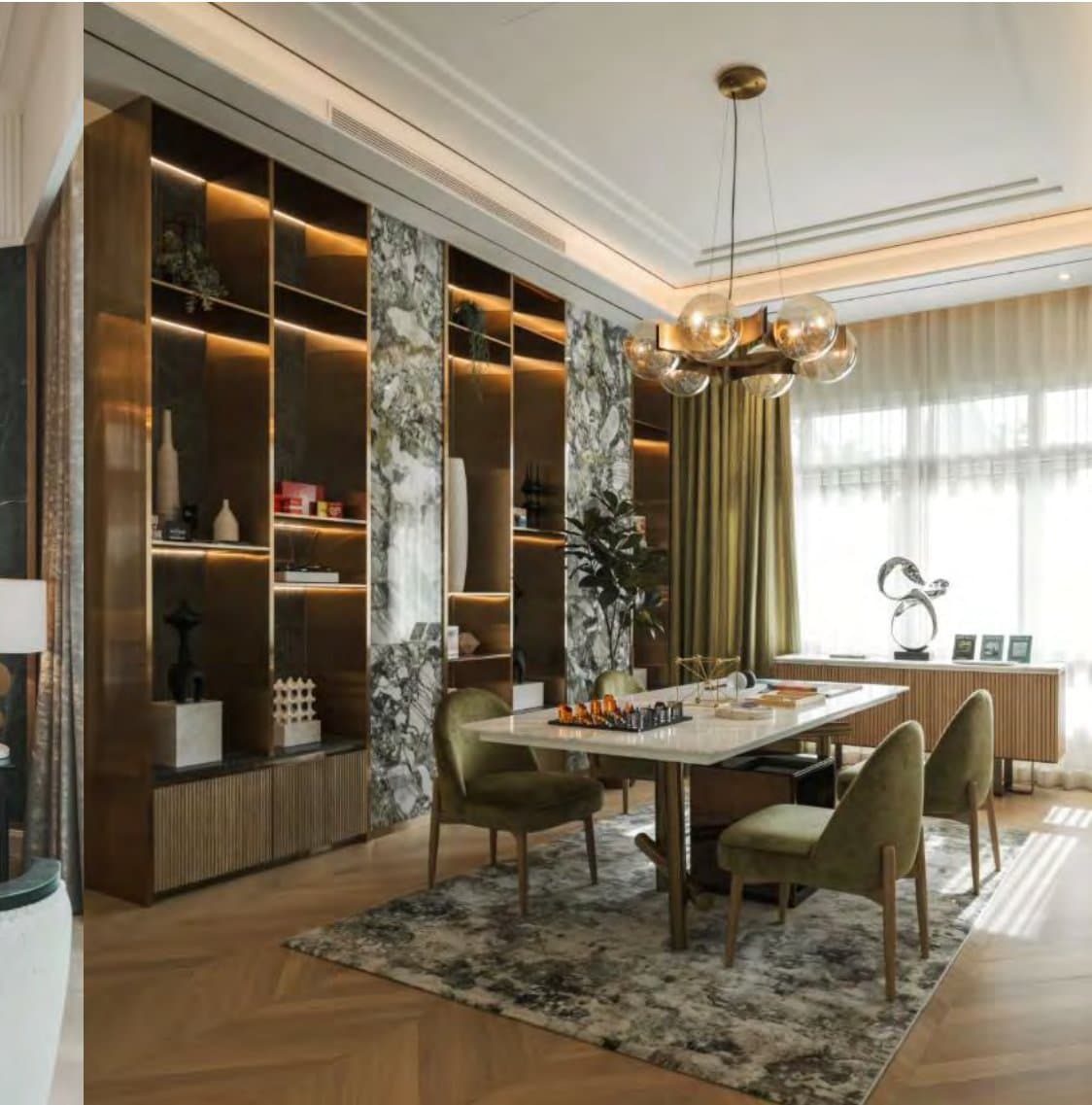 Games room with backlit brass cabinets, green-veined marble panels, olive-velvet chairs and a marble table set for a game of chess.