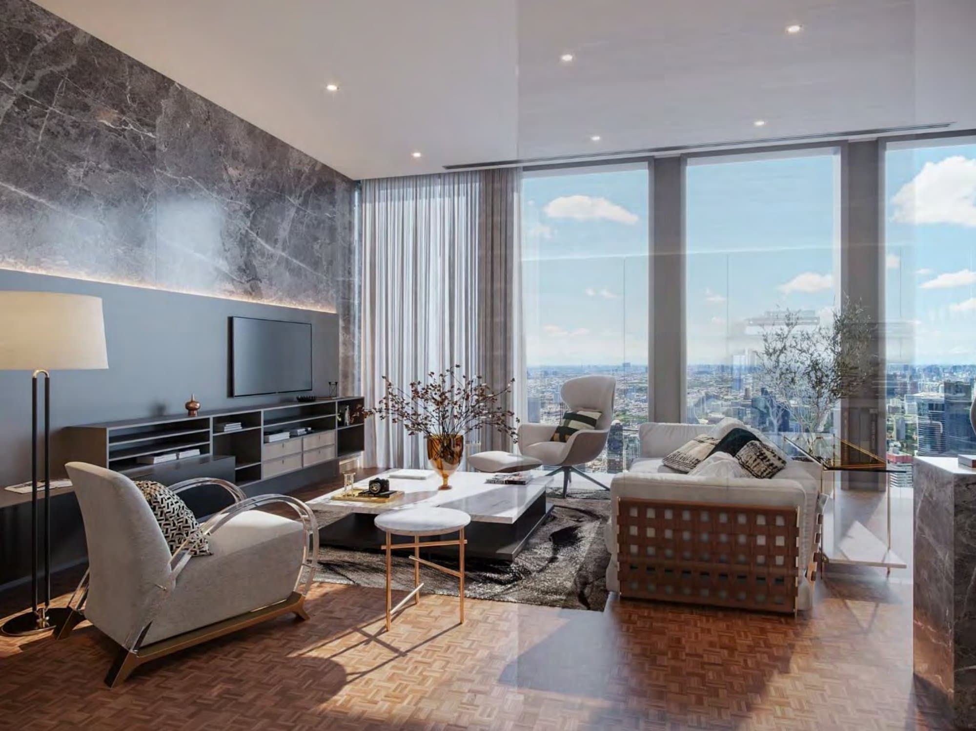 Living room with grey marble feature wall, low travertine coffee table, sculptural white armchairs and floor-to-ceiling windows framing the Bangkok skyline.